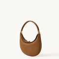 Luna Bag: A brown full-grain leather shoulder bag with gold hardware and a curved silhouette.