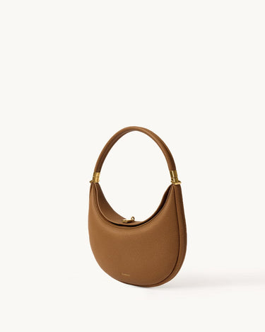 Luna Bag: A brown full-grain leather shoulder bag with gold hardware and a curved silhouette.