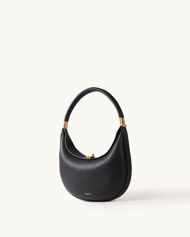 Black leather Luna Bag with gold hardware and curved handle.