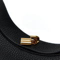 Black textured leather Luna Bag with gold Songmont logo closure.