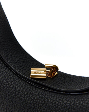 Black textured leather Luna Bag with gold Songmont logo closure.