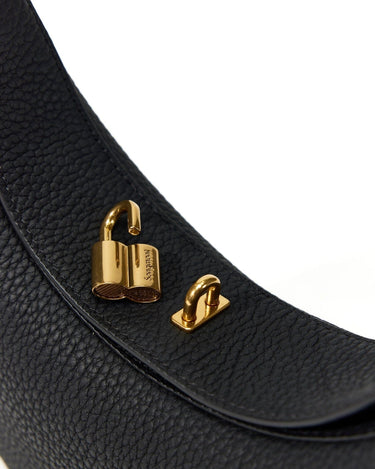 Black full-grain leather Luna Bag with open gold hardware clasp featuring Songmont logo.