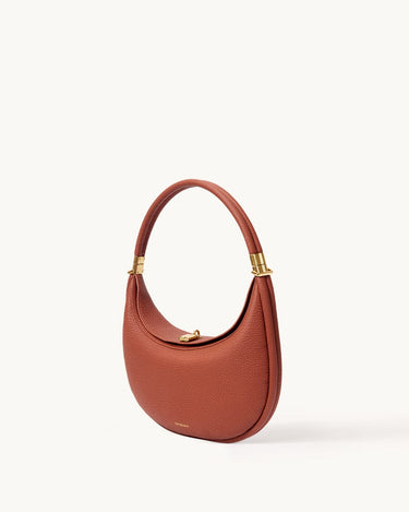 Oolong Luna Bag with gold hardware and adjustable strap, made of pebbled full-grain leather.