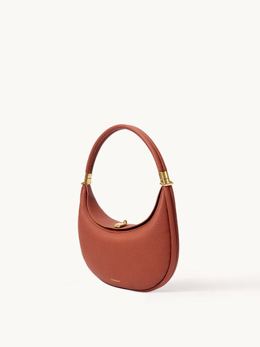 Oolong Luna Bag with gold hardware and adjustable strap, made of pebbled full-grain leather.