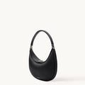 Black Luna Bag with silver-tone hardware, made of full-grain leather, curved shoulder bag