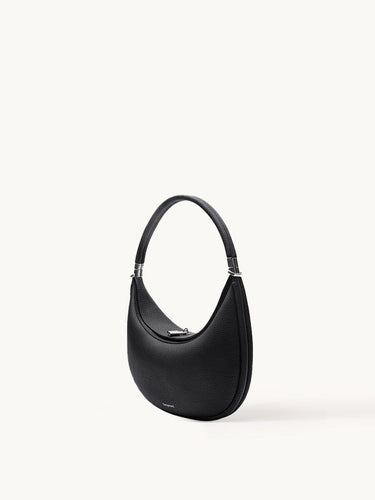 Black Luna Bag with silver-tone hardware, made of full-grain leather, curved shoulder bag