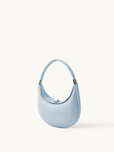 Sky blue Luna Bag crafted from full-grain leather with a silver-tone clasp and adjustable strap.