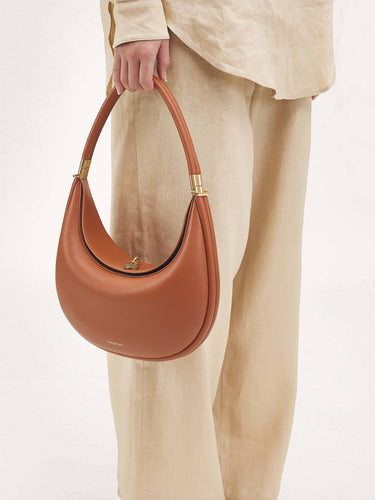 Luna Bag in Eco Caramel vegan leather with gold hardware. Adjustable strap for shoulder, crossbody, or hand carry.