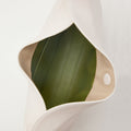 Open white vegan leather Luna Bag with green interior, showcasing texture and gold hardware.