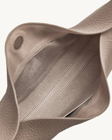 Interior of a gray full-grain leather Luna Bag, showing fabric lining and stitching.