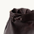 Medium Gather Bag Set in rich, textured brown leather with gathered opening and knot detail.