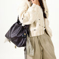 Medium Gather Bag Set in Ebony, worn by a woman in a cream distressed sweater and beige pants.