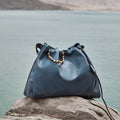 Blue Nappa leather Medium Gather Bag Set with beaded drawstring on rock by water