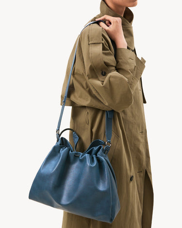 Medium Gather Bag Set in navy blue Nappa leather with adjustable straps and silver hardware.