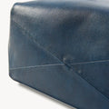 Medium Gather Bag Set in navy blue leather, showing textured material and stitched details.