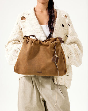 Ochre Suede Medium Gather Bag Set with drawstring, leather charm, and braided straps.