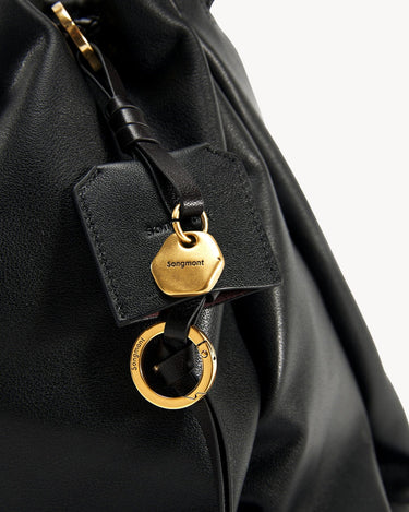 Black pebbled leather Medium Gather Bag Set with gold hardware and Songmont logo detail.
