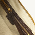 Large Luna Hobo Bag interior: brass zipper, dark brown leather pull tab with Songmont logo, beige herringbone lining.