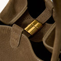 Medium Song Bag in Agarwood: Textured nubuck leather with gold magnetic closure, "Songmont" logo detail.