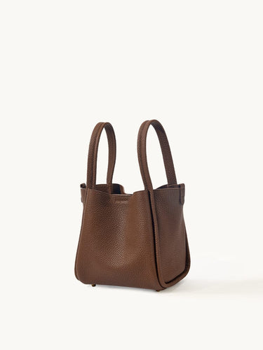 Medium Song Bag in chocolate brown textured full-grain leather with two top handles.