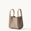 Medium Song Bag in Cream Apricot: Full-grain leather bucket bag with top handles and magnetic closure.