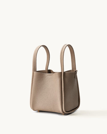 Medium Song Bag in Cream Apricot: Full-grain leather bucket bag with top handles and magnetic closure.