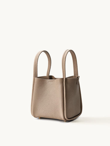 Medium Song Bag in Cream Apricot: Full-grain leather bucket bag with top handles and magnetic closure.