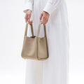 Medium Song Bag in Cream Apricot, full-grain leather with a textured finish and gold hardware details.