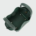 Medium Song Bag in Emerald green, showing its structured bucket design and spacious interior with golden hardware details.