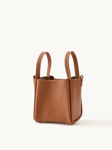 Medium Song Bag in rich brown pebbled leather with dual top handles and gold-tone hardware.