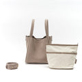 Medium Song Bag in Haze nubuck leather with a removable canvas inner pouch and adjustable strap.