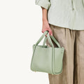 Medium Song Bag in Jade, crafted from textured full-grain leather with a single compartment and magnetic closure.