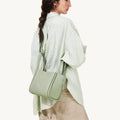 Medium Song Bag in Jade green pebbled leather with gold hardware and adjustable strap.