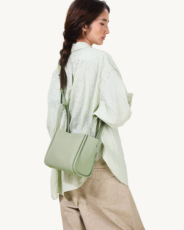 Medium Song Bag in Jade green pebbled leather with gold hardware and adjustable strap.