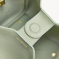 Close-up of Medium Song Bag in Jade, featuring textured full-grain leather and subtle "songmont" gold lettering.