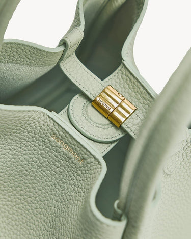 Medium Song Bag in Jade green pebbled leather with gold clasp detail and embossed logo.