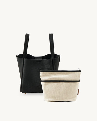 Medium Song Bag in Onyx black textured leather with removable cream fabric inner pouch.