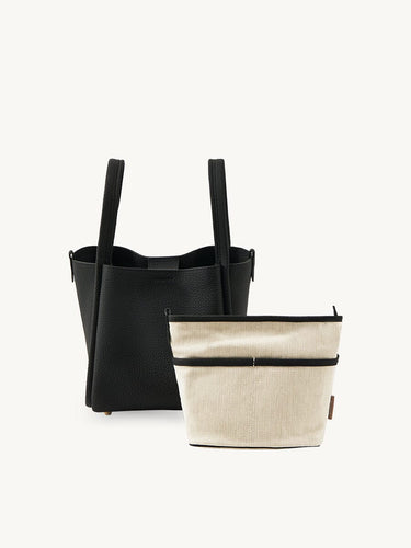 Medium Song Bag in Onyx black textured leather with removable cream fabric inner pouch.