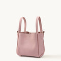 Medium Song Bag in pink textured leather, a stylish bucket bag with dual handles.