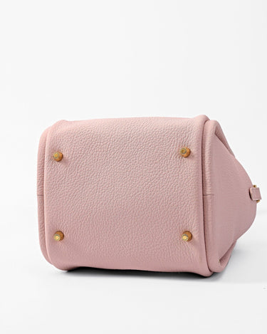 Pink leather Song Bag with gold feet and brand logo, showing bottom detail.