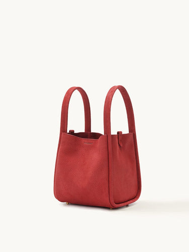 Medium Song Bag in Lucky Red pebbled leather, with top handles and gold feet.