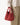 Medium Song Bag in vibrant Poppy red nubuck leather with a unique O-shaped structure and twin top handles.