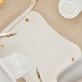 Close-up of the interior of a white vegan leather Medium Song Bag, showing textured material and gold-tone hardware.