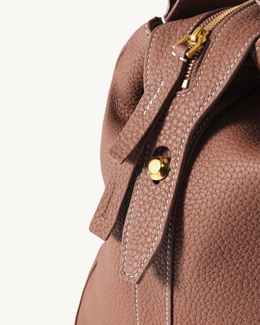 Medium Yore Duffle Bag in Golden Brown full-grain leather with gold hardware and white stitching.