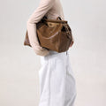 Medium Yore Duffle Bag in Sandal color, made from vegetable-tanned leather, ideal for travel and daily use.