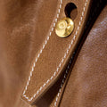 Medium Yore Duffle Bag, Sandal, vegetable-tanned leather, white stitching, gold snap closure with logo.
