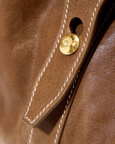 Medium Yore Duffle Bag, Sandal, vegetable-tanned leather, white stitching, gold snap closure with logo.