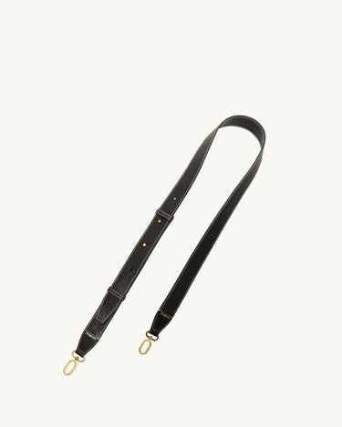 Black leather shoulder strap with white stitching and gold clasps for the Medium Yore Duffle Bag.