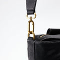 Black Yore Duffle Bag with gold 'Songmont' clasp and white stitching
