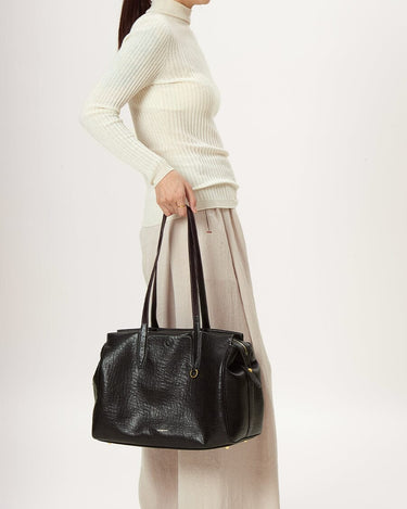 Medium Yore Duffle Bag in black vegan leather, a stylish and functional travel bag with textured finish.